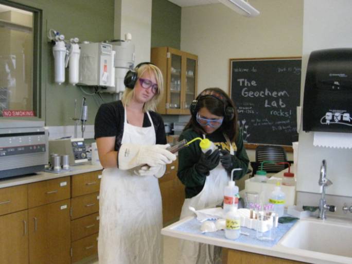 Students preparing samples in the geochemistry lab