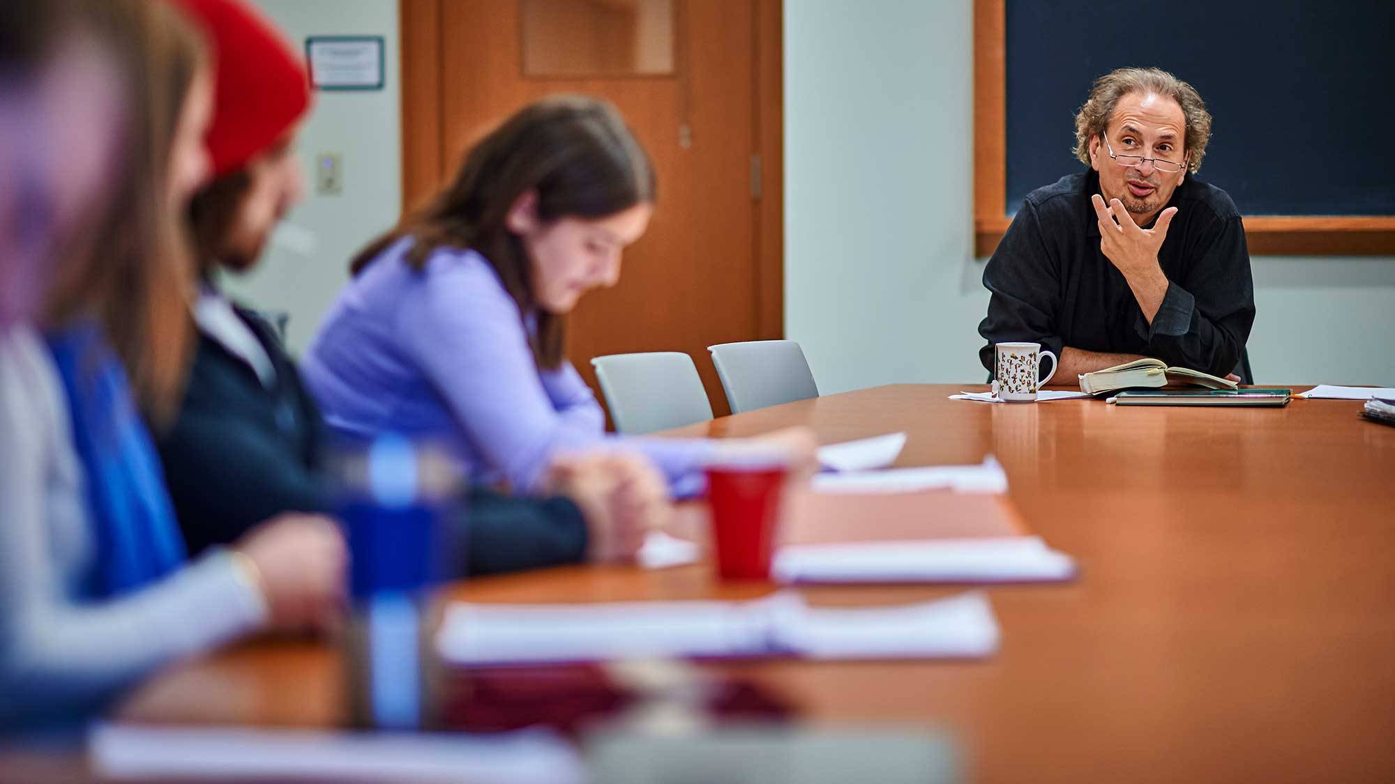 Peter Balakian teaches students around a table