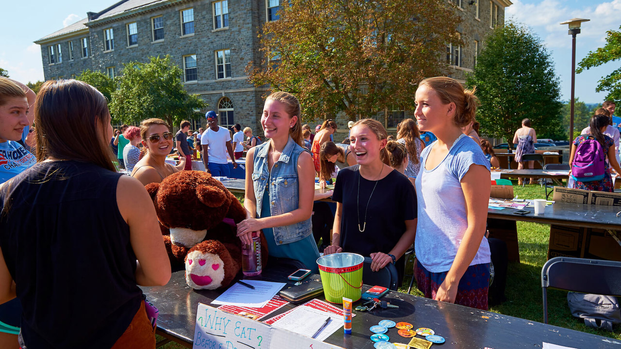 Three leaders of a Colgate club recruit members at the student involvement fair
