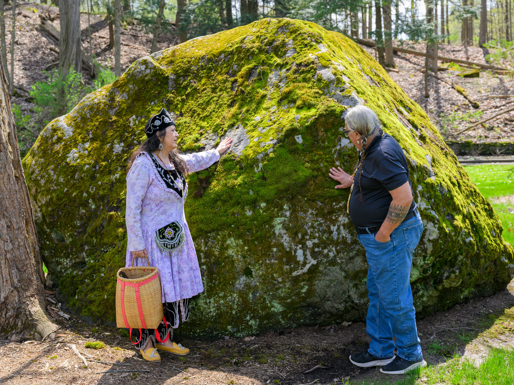 Community Liaison Lisa Latocha of the Oneida Indian Nation and Chief Mark Tayac of the Piscataway Indian Nation share a moment at the Oneida rock at Colgate University