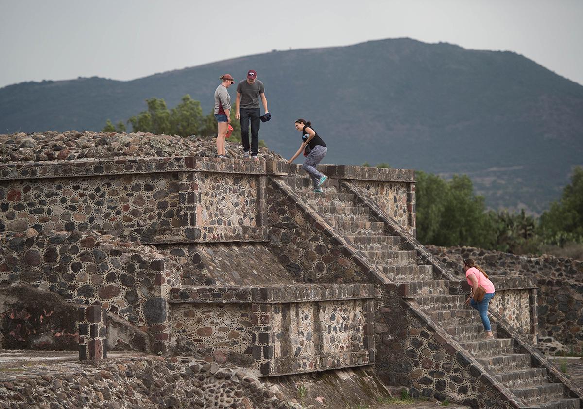 Colgate students climb a stepped pyramid at the ancient city of Teotihuacán