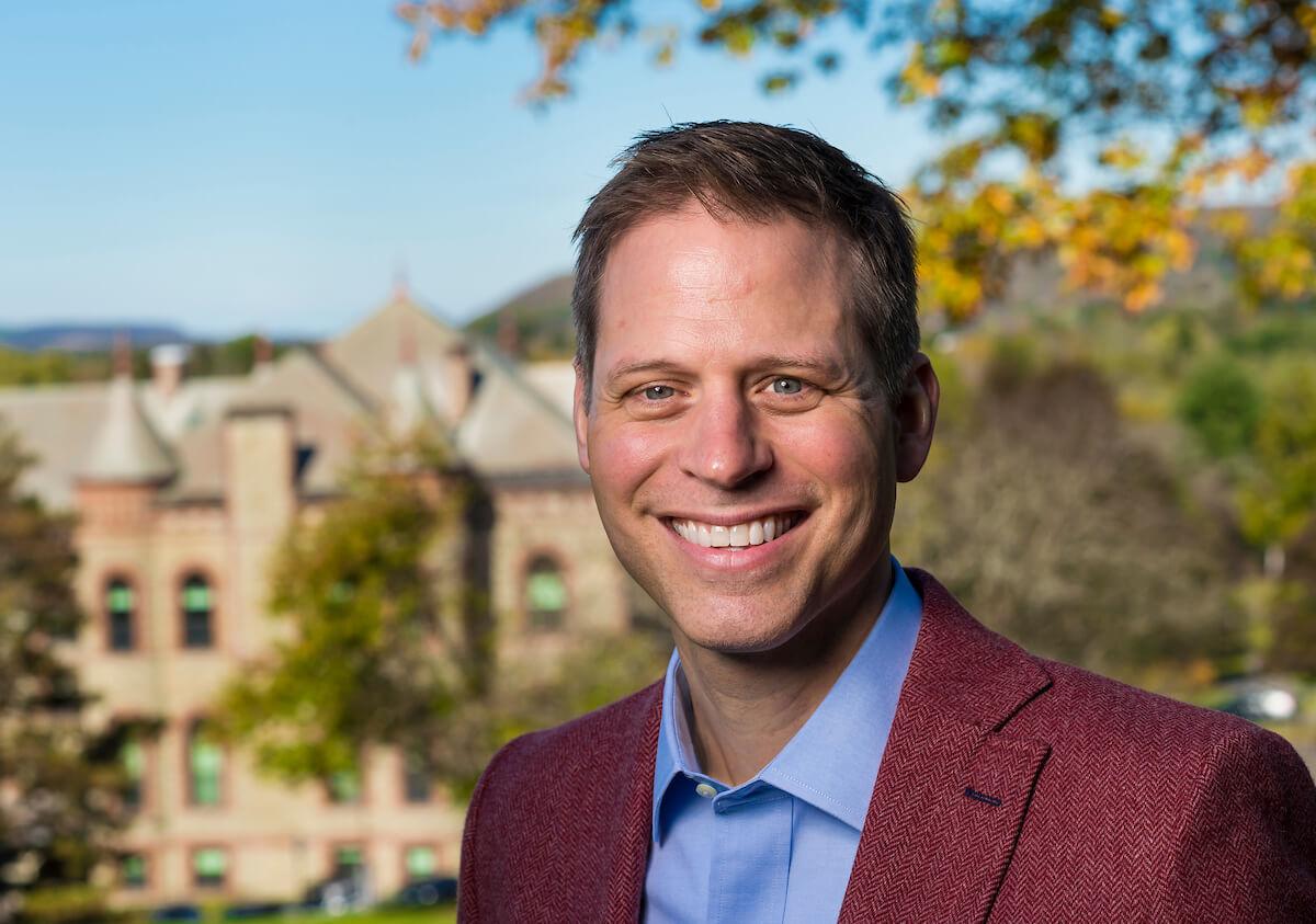 A photograph of Paul McLoughlin, vice president and dean of the college, outside in Hancock Commons