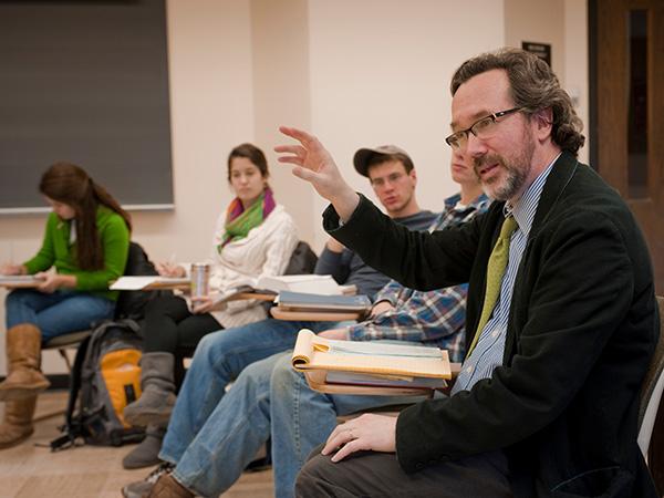 Professor Barrera and students sitting in a discussion circle