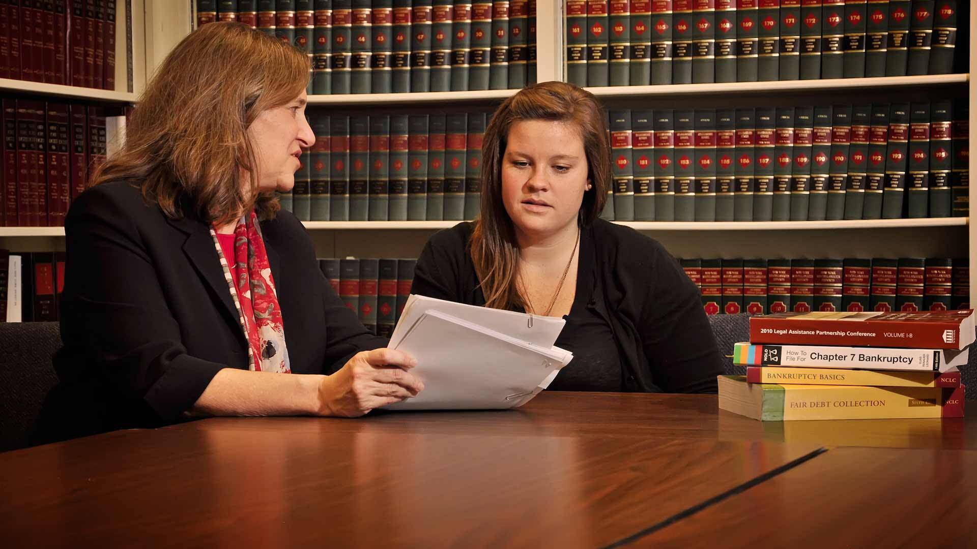 Professor and student reviewing documents