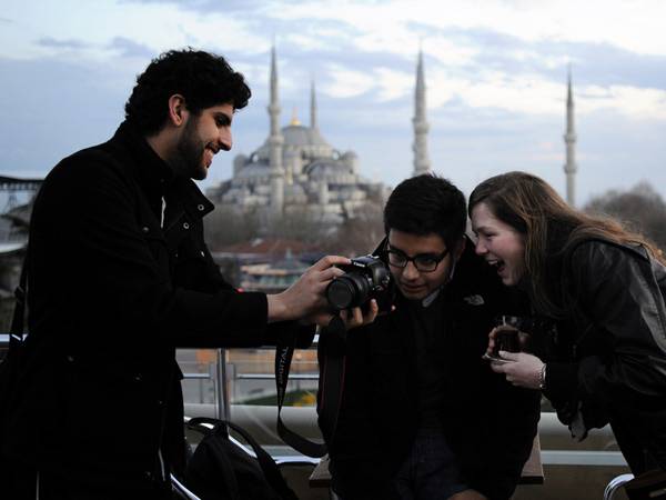 Members of the Interfaith study group tour traveling in Istanbul take in the sights from the top of their hotel overlooking the Blue Mosque.