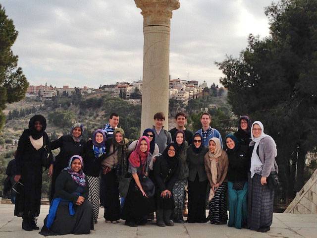Students on the Jerusalem Extended Study take a group shot in front of a pillar
