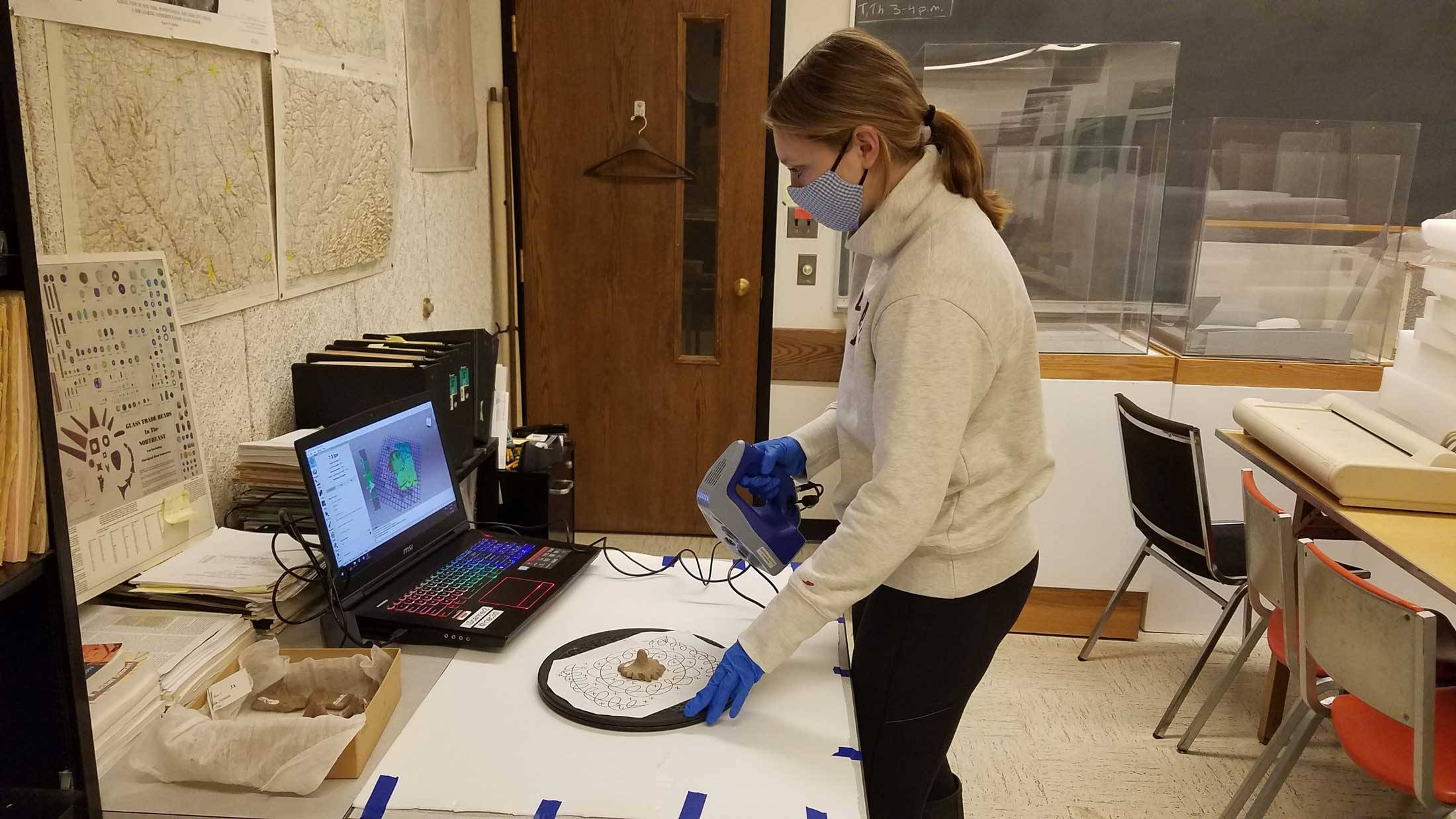 Student scans artifact with 3D scanner