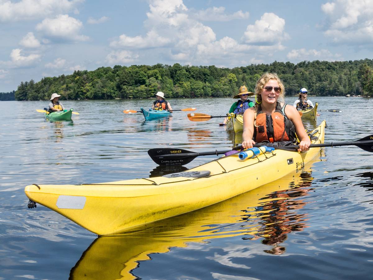 Students kayaking during wilderness adventure.