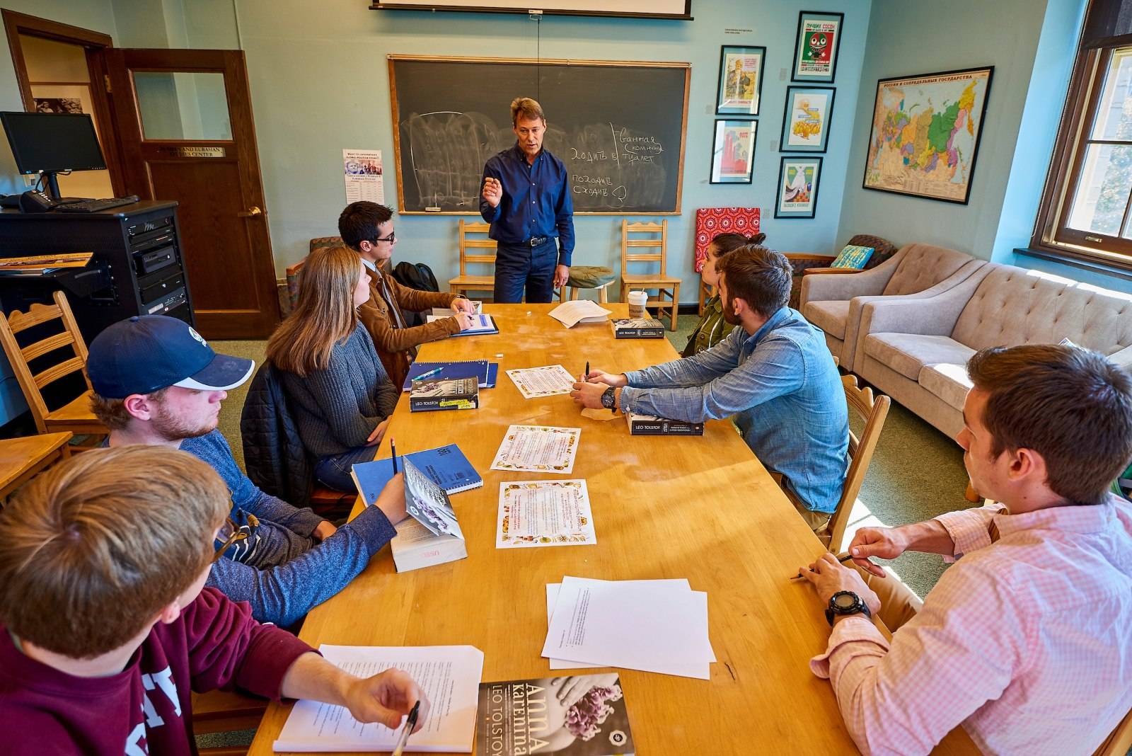 Students at a table with their professor during class