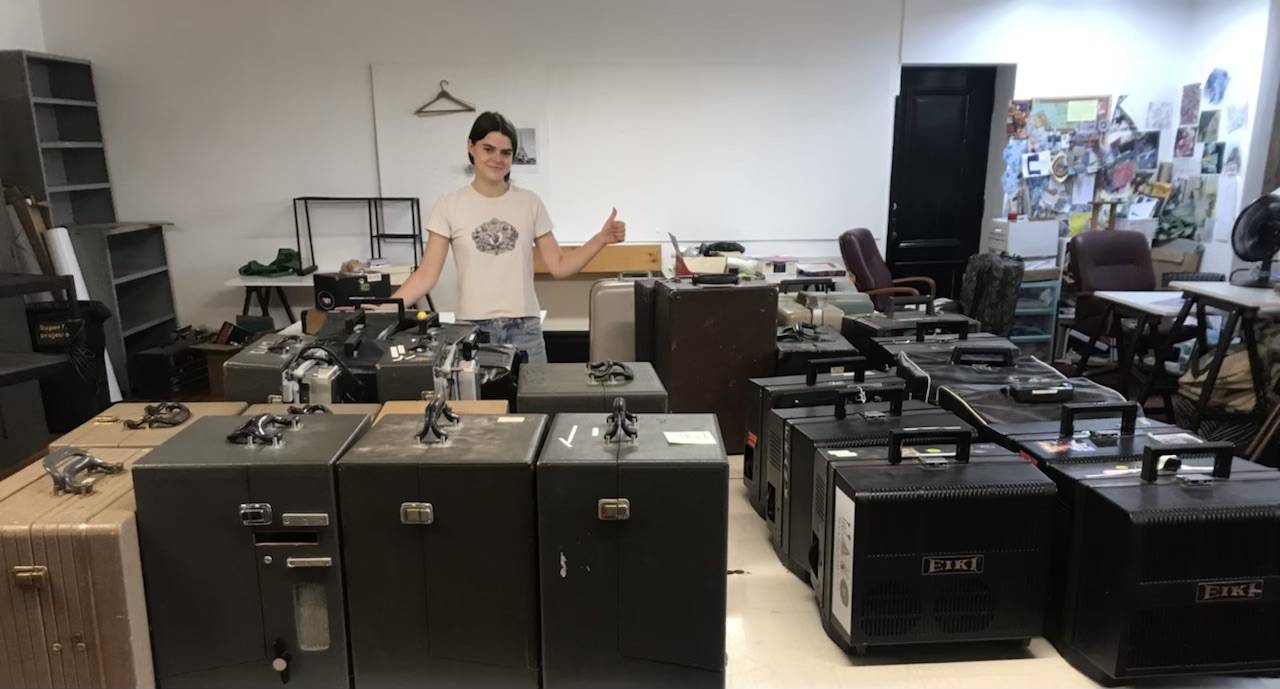 Leila getting ready to inspect and repair the collection of film projectors at VSW
