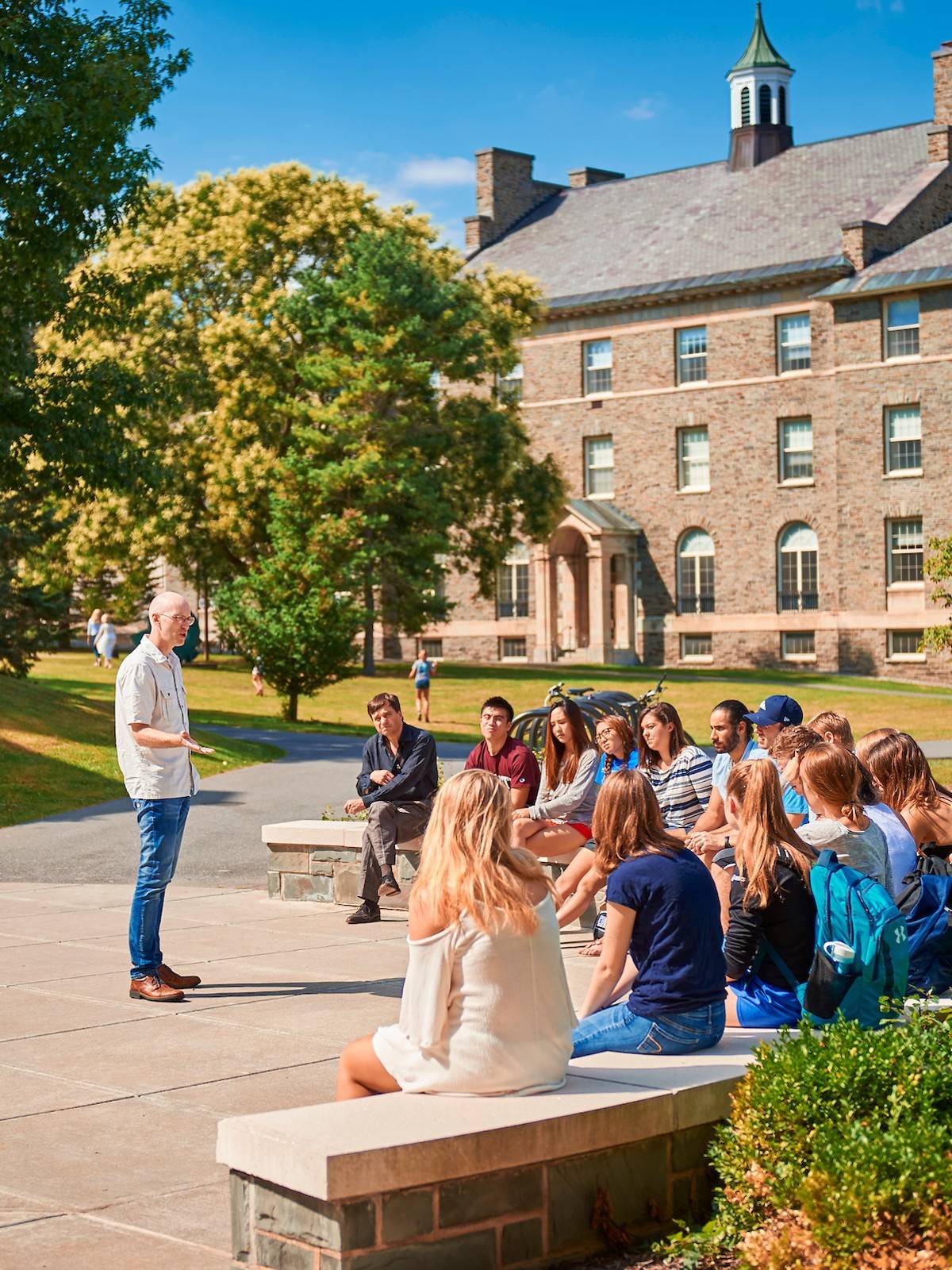 Professor teaches a class outdoors on a sunny day