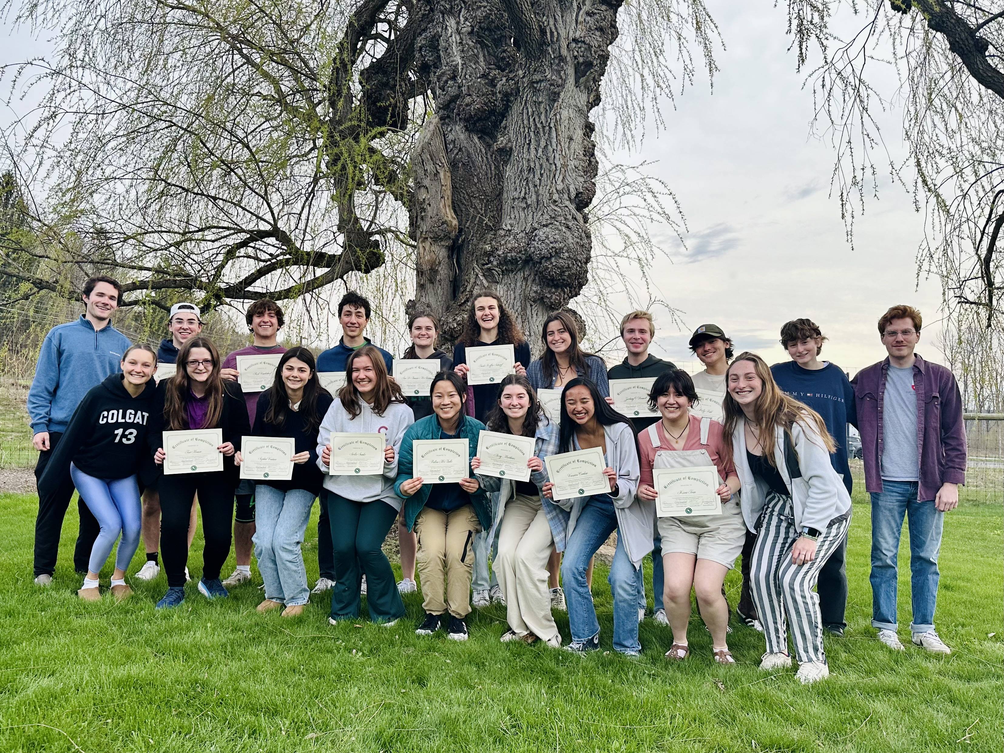 Group photo of the 18 S-Reps holding their certificates upon completing the year-long S-Rep Program.