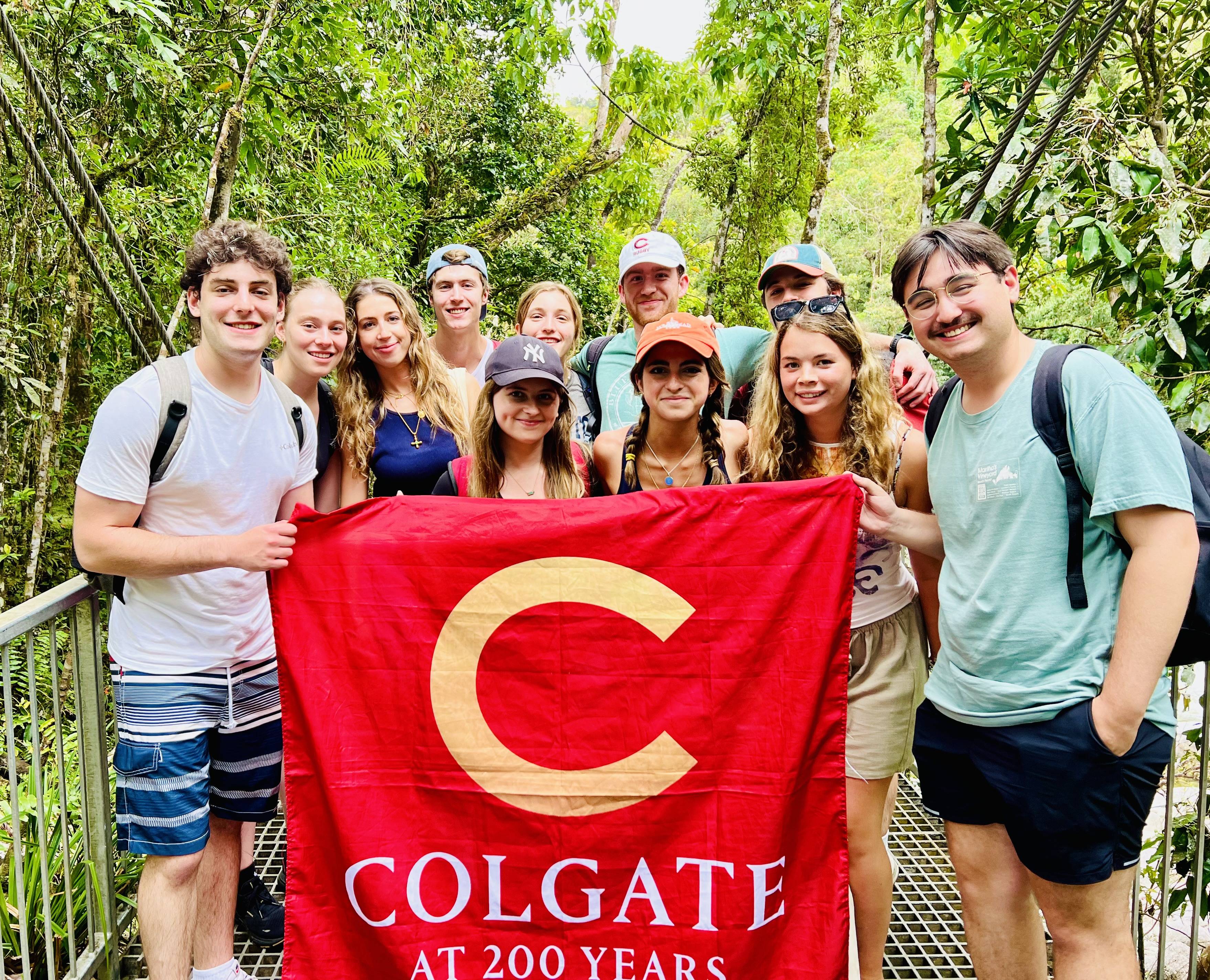 Photo of student group holding up Colgate flag.