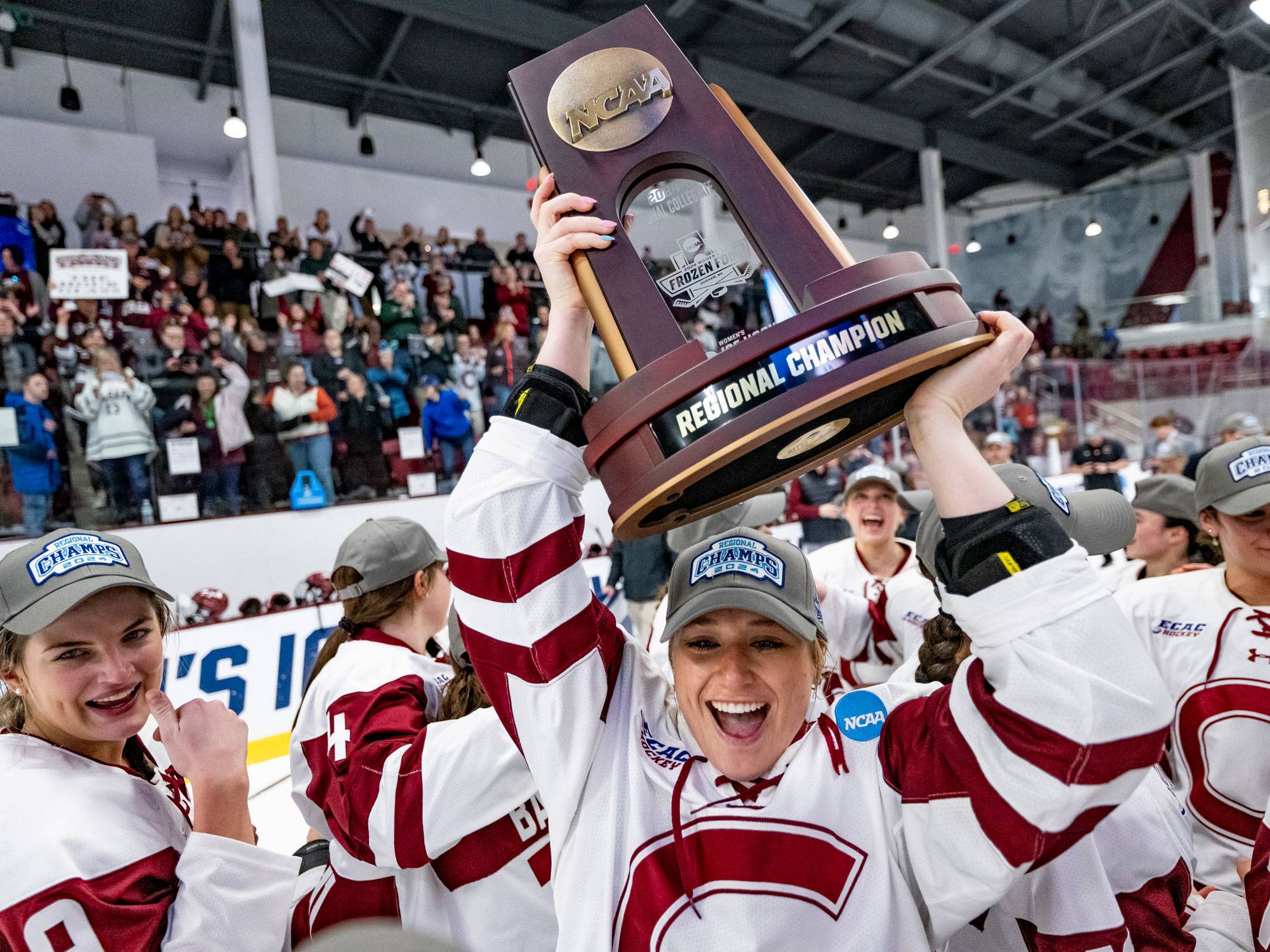 Hockey player holds up trophy