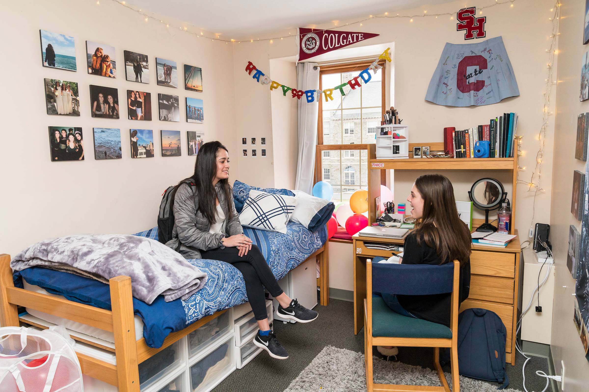 Two students chat in their residence hall room