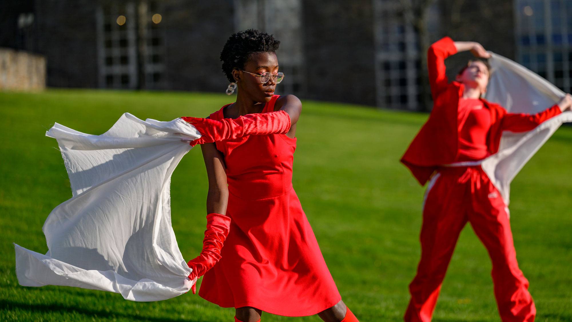 Students dance on green lawn