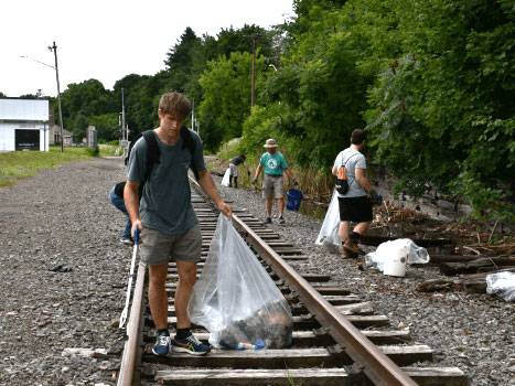 Ayden Simpson '25 picking up trash along the future Chenango Heritage Rail Trail.