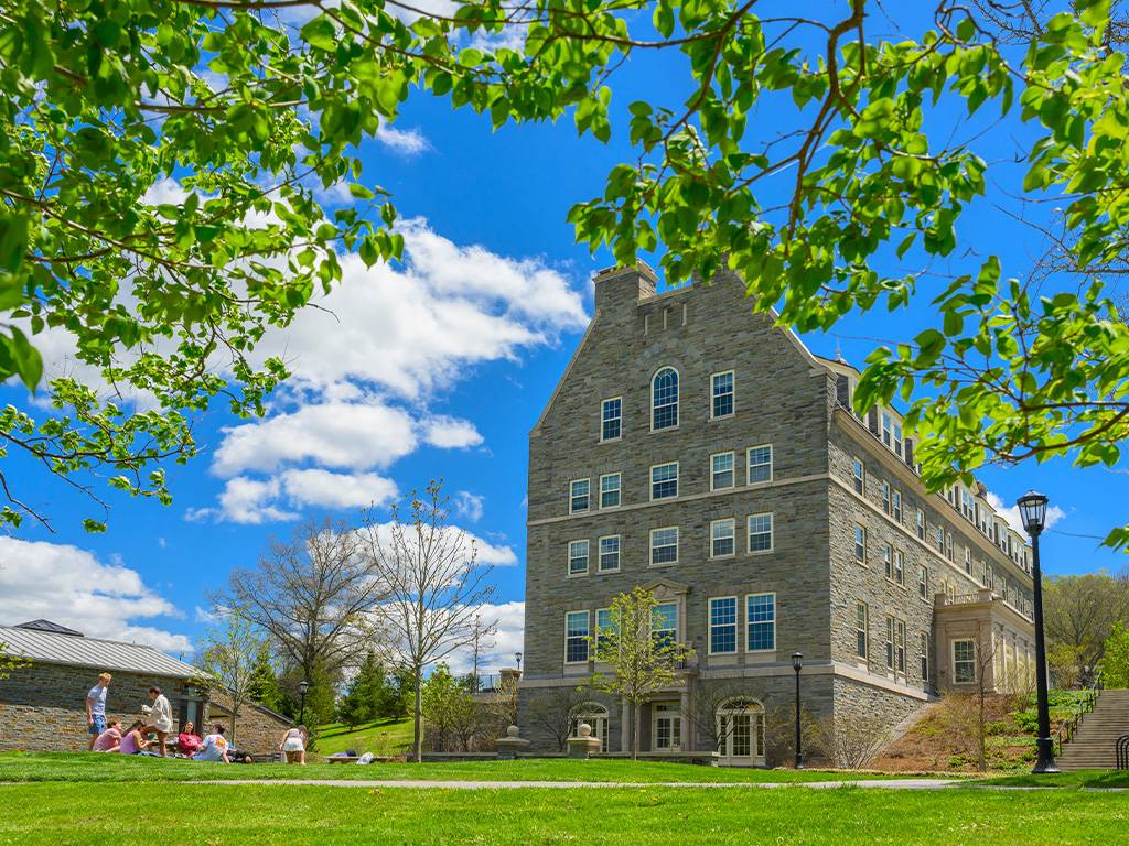 Students enjoy a sunny day on the grounds outside Burke Hall.