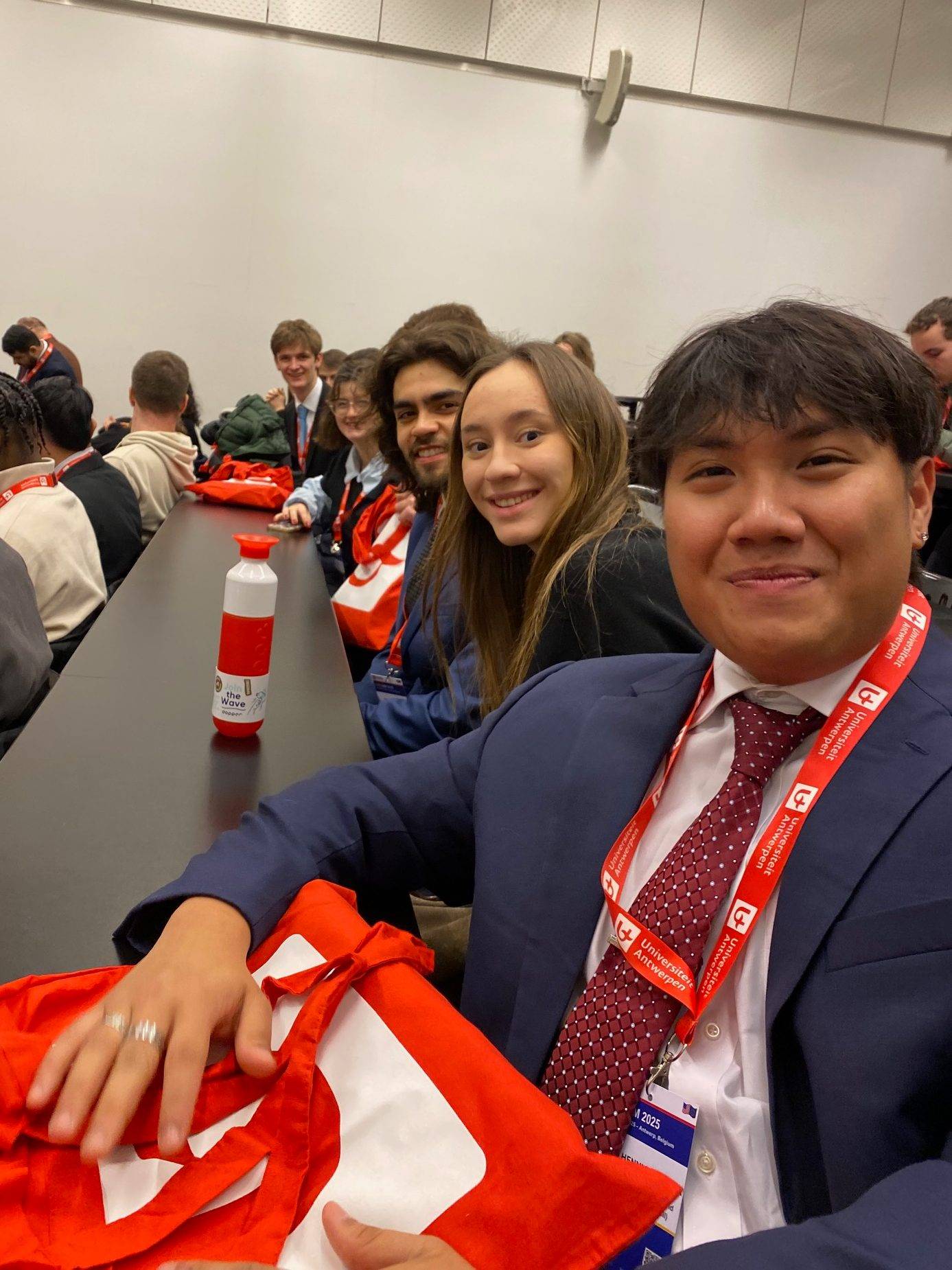 Bryan (Tai) Pham wins best delegate award at EuroSim 2025, seated with other students from the Colgate delegation.