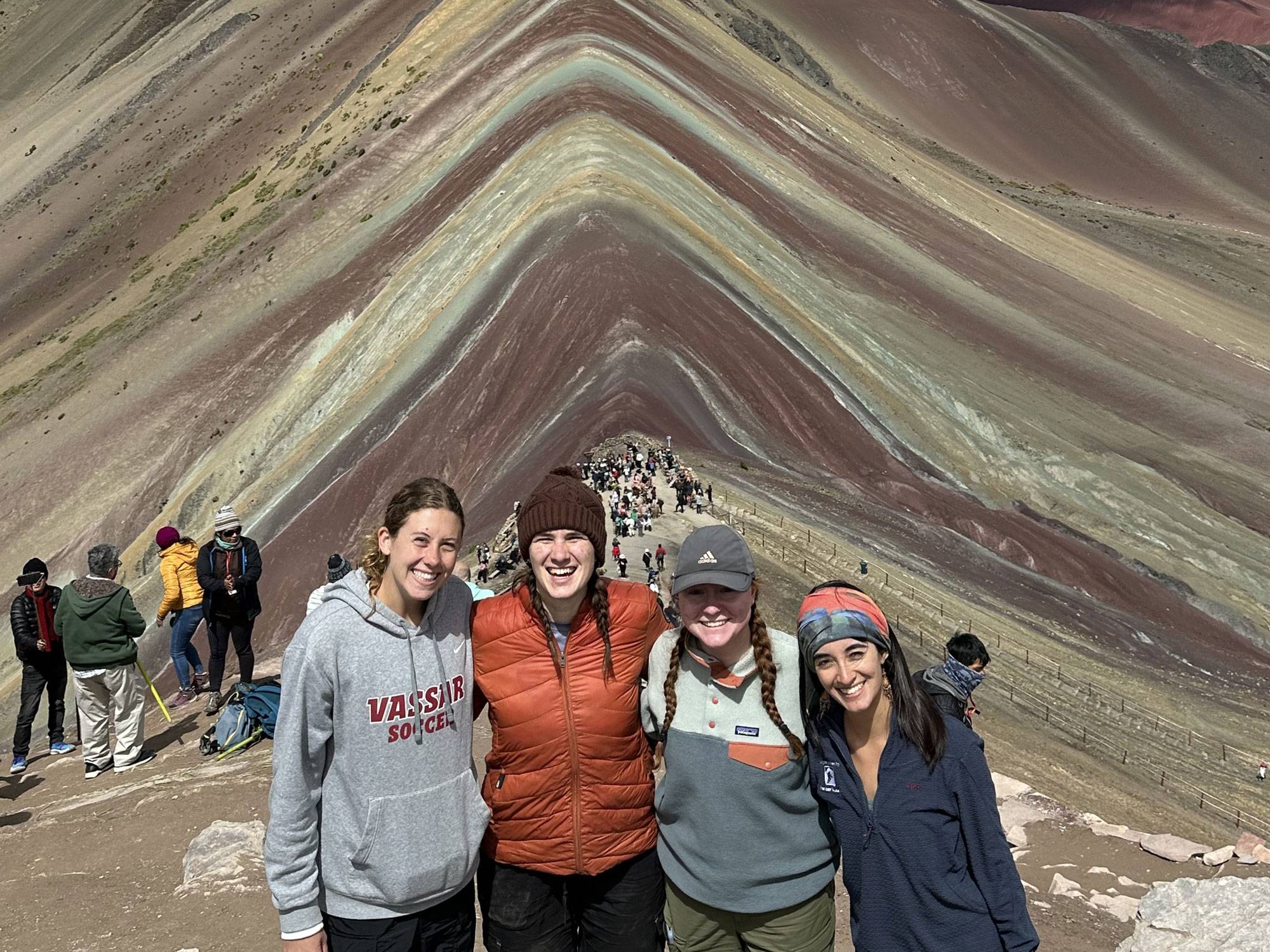 Barbara Gonzales Fuentes ’25 (on far right) in front of the Rainbow Mountain, or Vinicunca, Peru. 