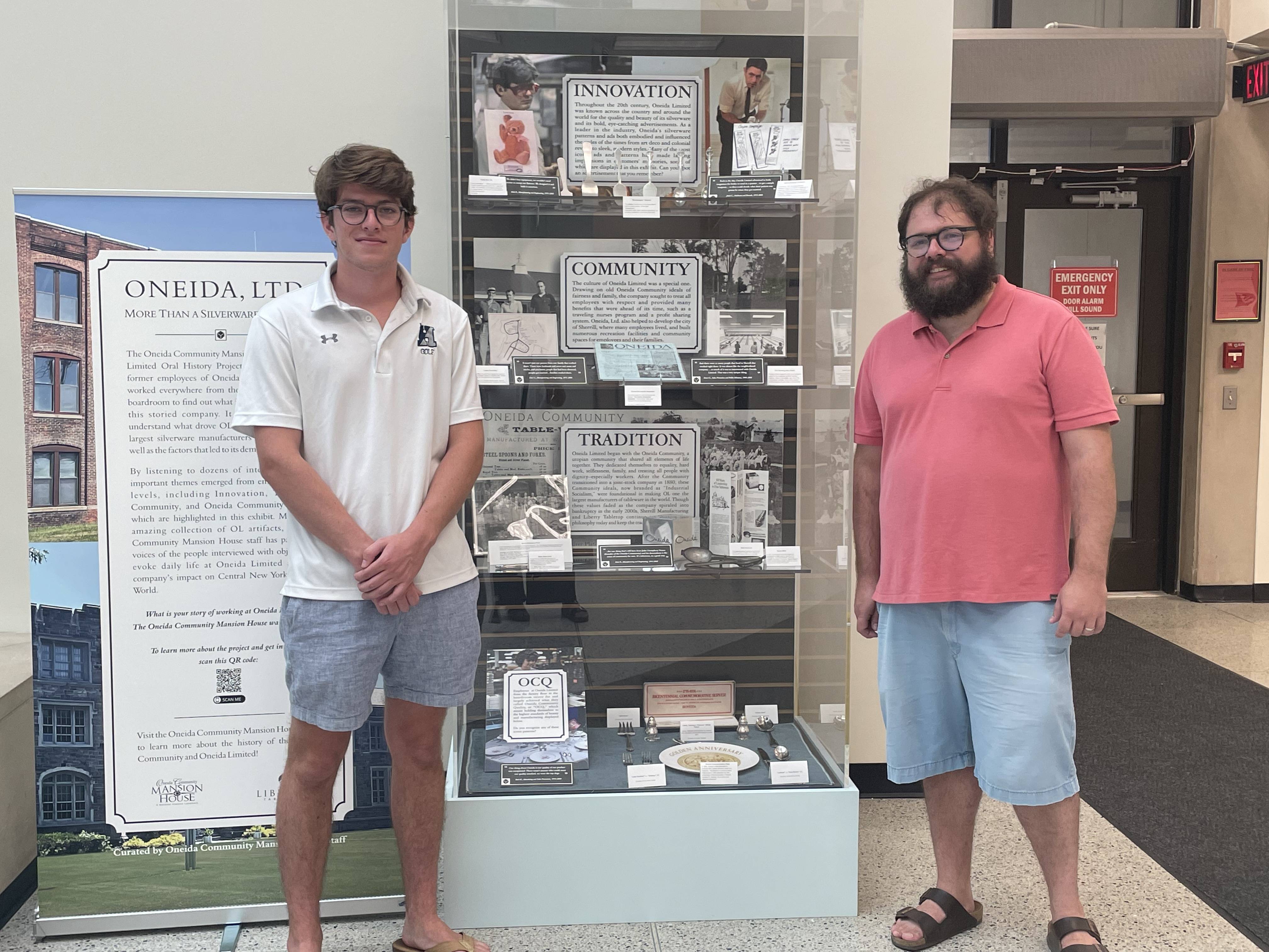 Stuart Sopko '24 and Tom Guiler of the Oneida Mansion House stand by finished installation of exhibit entitled "Oneida, Ltd.: More than a Silverware Company" at the Madison County Courthouse.