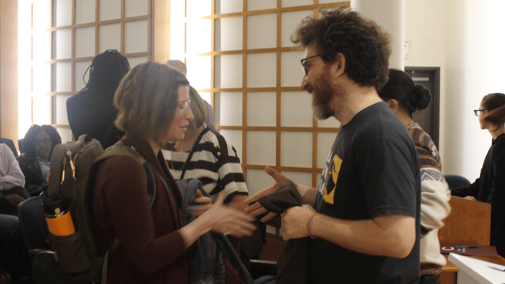 An image of Julian Boal greeting an audience member after his lecture.