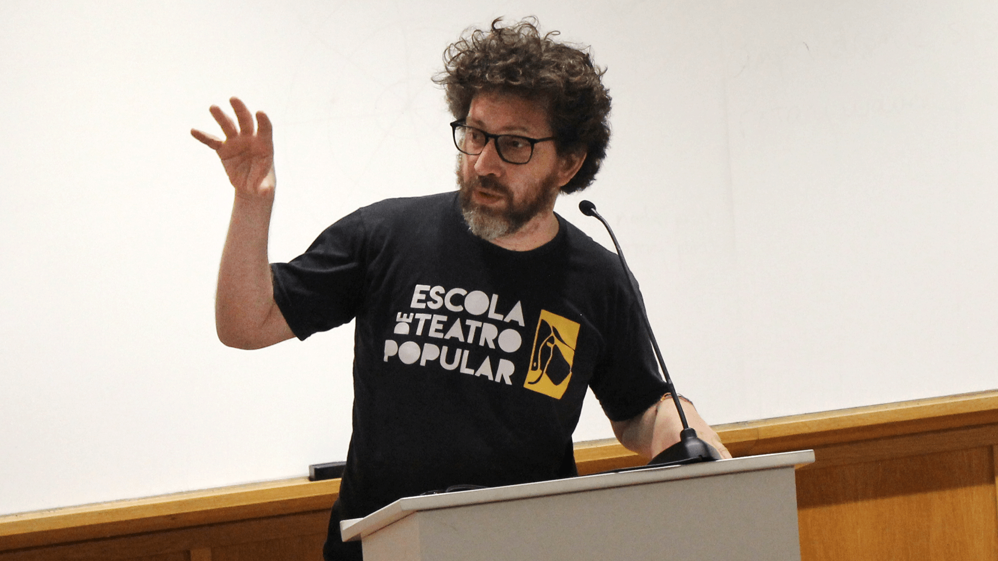 Julian Boal motions with his arm to illustrate a point during his lecture.