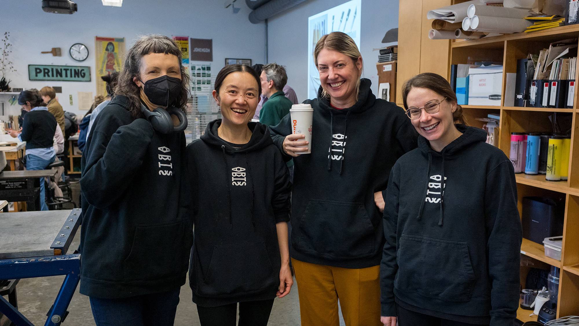 Art Department Professors Margaretha Haughwout, Yi Cui, Brynn Hatton, and Rachel Boate wearing their Art Department logo hoodie sweatshirts at the Yang Hongwei printmaking workshop on November 16, 2024.