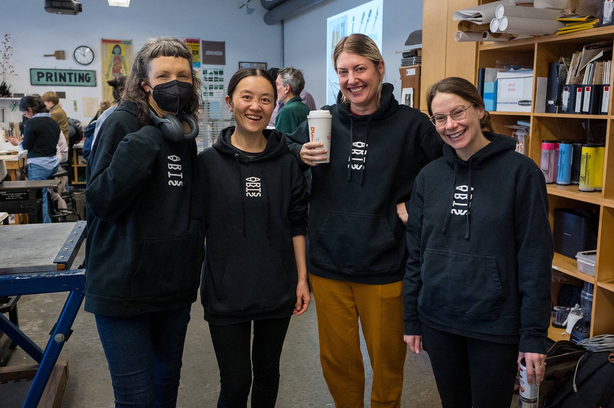 Art Department Professors Margaretha Haughwout, Yi Cui, Brynn Hatton, and Rachel Boate wearing their Art Department logo hoodie sweatshirts at the Yang Hongwei printmaking workshop on November 16, 2024.