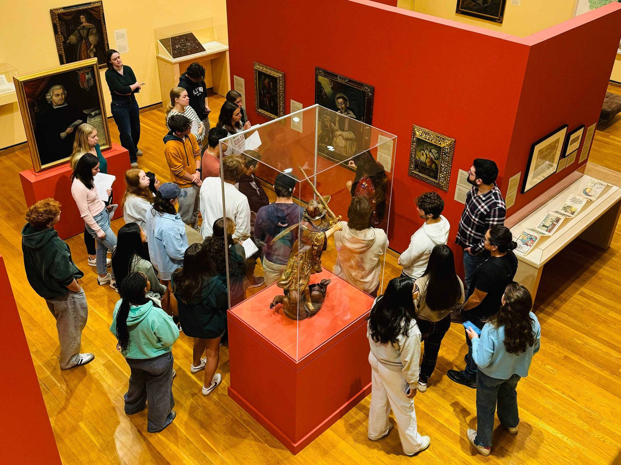 Students gather around display at museum exhibition