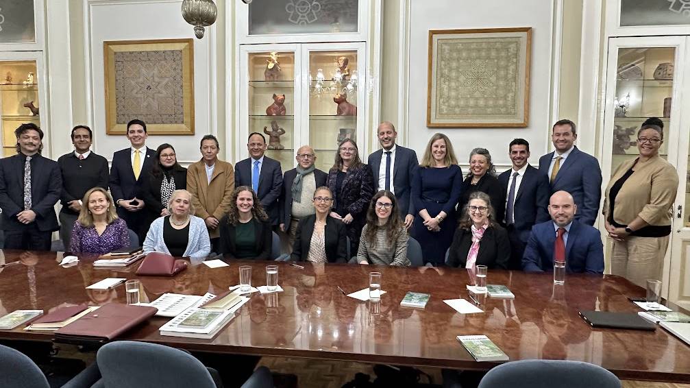 Colgate delegation and hosts gathered at conference table