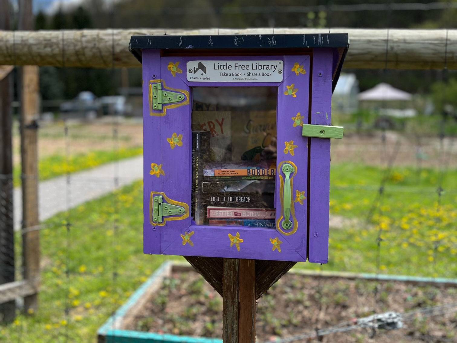 Little library box in front of community garden